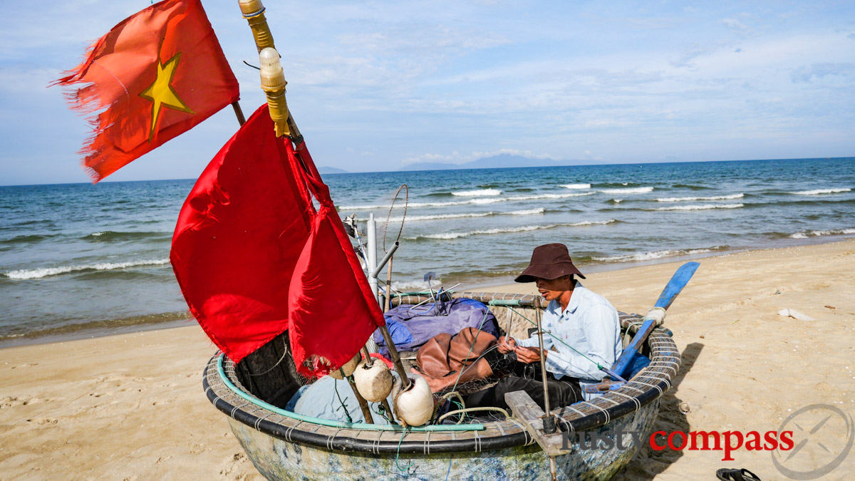 Patching up the net before heading out to sea - An Bang Beach